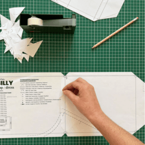 Hand sellotaping sewing pattern pieces together